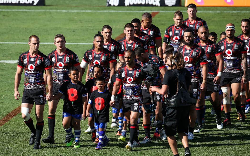 Captain Simon Mannering (L) leads the Warriors out onto Mt Smart Stadium on ANZAC Day against the Gold Coast  Titans, on Saturday 25 April 2015