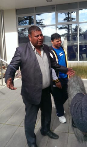 Satnam Singh, right, one of three men accused of people trafficking and a supporter.