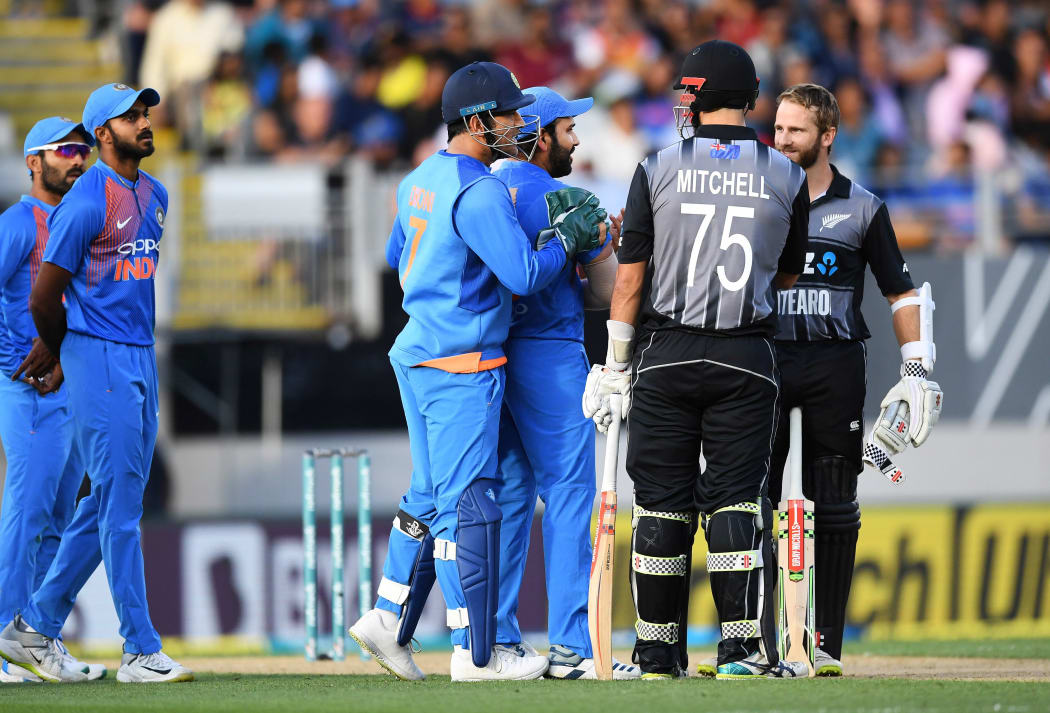 Daryl Mitchell is given out as Kane Williamson and India's MS Dhoni and Rohit Sharma look on.
New Zealand Black Caps v India. Twenty20 International cricket. 2nd T20. Eden Park, Auckland, New Zealand. Friday 8 February 2019. © Copyright photo: Andrew Cornaga / www.photosport.nz
