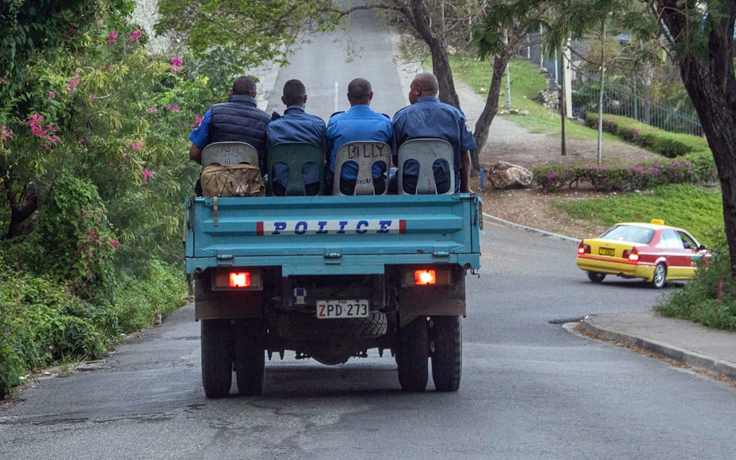 Police commute on a road as the close streets leading to Parliament house in Port Moresby on May 28, 2019. Papua New Guinea Prime Minister Peter O'Neill stalled his announced resignation and took legal action to prevent a vote of no confidence on May 28, deepening the country's political crisis. (Photo by Ness Kerton / AFP)