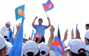 Cambodia's Prime Minister Hun Sen and leader of the ruling Cambodian People's Party (CPP) waves to supporters.