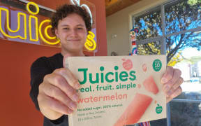 Kaitāia College student Lennox Goodhue-Wikitera with the new watermelon-flavoured Juicies, which he helped to shoot some social media content for after being invited to visit the factory in the top of the South Island.