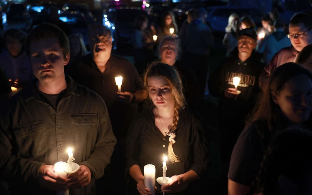 People attend a candlelight vigil to honor the victims of the Lewiston shootings on October 28, 2023 in Lisbon, Maine.