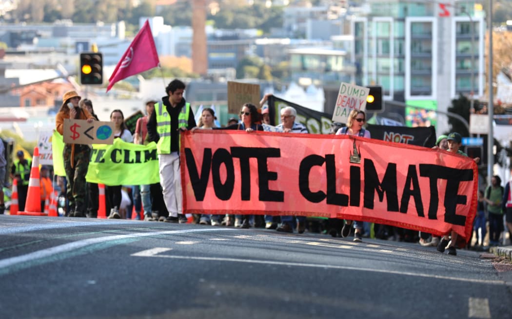 Climate advocates take part on a march in Auckland on 26 May, 2023, demanding New Zealand reduces its emissions, transition to regenerative agriculture, lower the voting age to 16 and respond to the climate crisis with tangata whenua at the center of decision making.