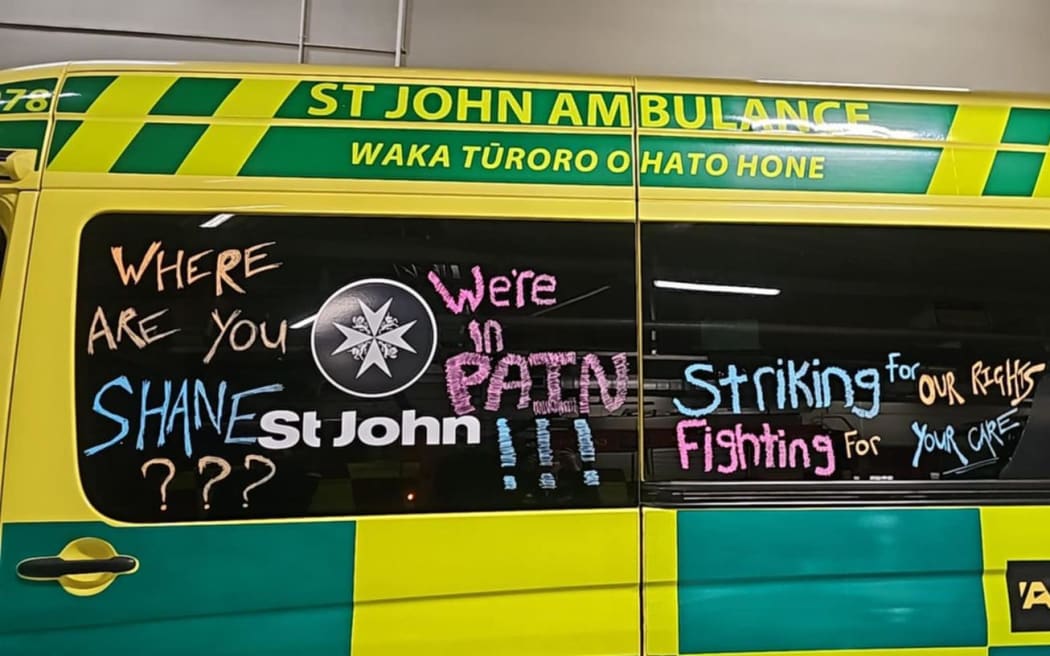 Hato Hone St John First Union members chalking ambulances with messages.
