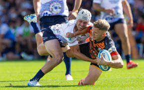 Chiefs Damian McKenzie is tackled by Brumbies Declan Meredith during the Super Rugby Paciﬁc.