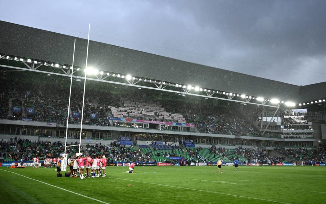 (FILES) Samoa's players warm up in the rain ahead of the France 2023 Rugby World Cup Pool D match between Argentina and Samoa at Stade Geoffroy-Guichard in Saint-Etienne, south-eastern France on September 22, 2023. French security services have arrested a Chechen man suspected of plotting an "Islamist-inspired" attack on a football game during the July-August Olympic Games, the interior ministry said on May 31, 2024. (Photo by Jeff PACHOUD / AFP)