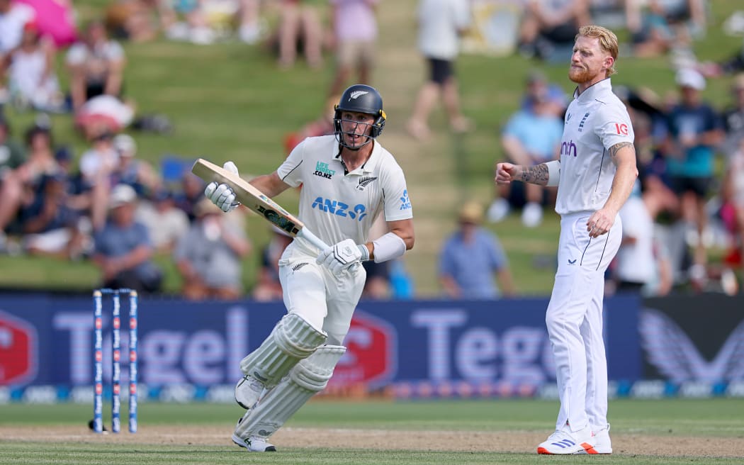 New Zealand batter Will Young runs and England captain Ben Stokes watches during the second day of the third cricket test at Seddon Park in Hamilton. 15 Dec, 2024.