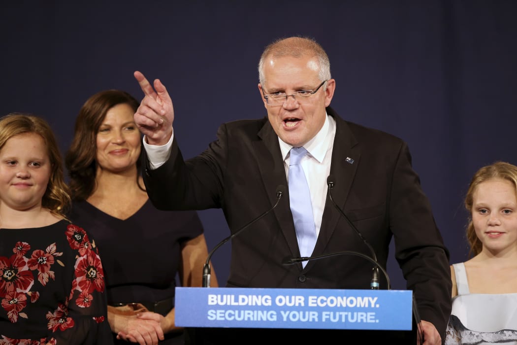Australian Prime Minister Scott Morrison speaks to party supporters flanked by his wife, Jenny, second left, and daughters Lily, right, and Abbey, after his opponent conceded in the federal election in Sydney, Australia.