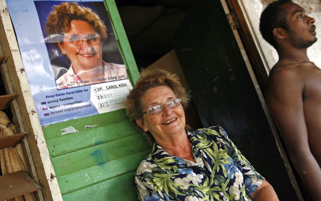 his photo taken 07 July, 2007 shows Australian-born Dame Carol Kidu (L) relaxing on the porch of her campaign headquarters in Pari village near Port Moresby. In March, 2007 Kidu was honoured with the US Secretary of State's International Woman of Courage Award for her promotion of human rights in PNG. AFP PHOTO/Torsten BLACKWOOD
TORSTEN BLACKWOOD / AFP