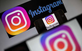 Logo of social network Instagram are displayed on the screen of a smartphone.