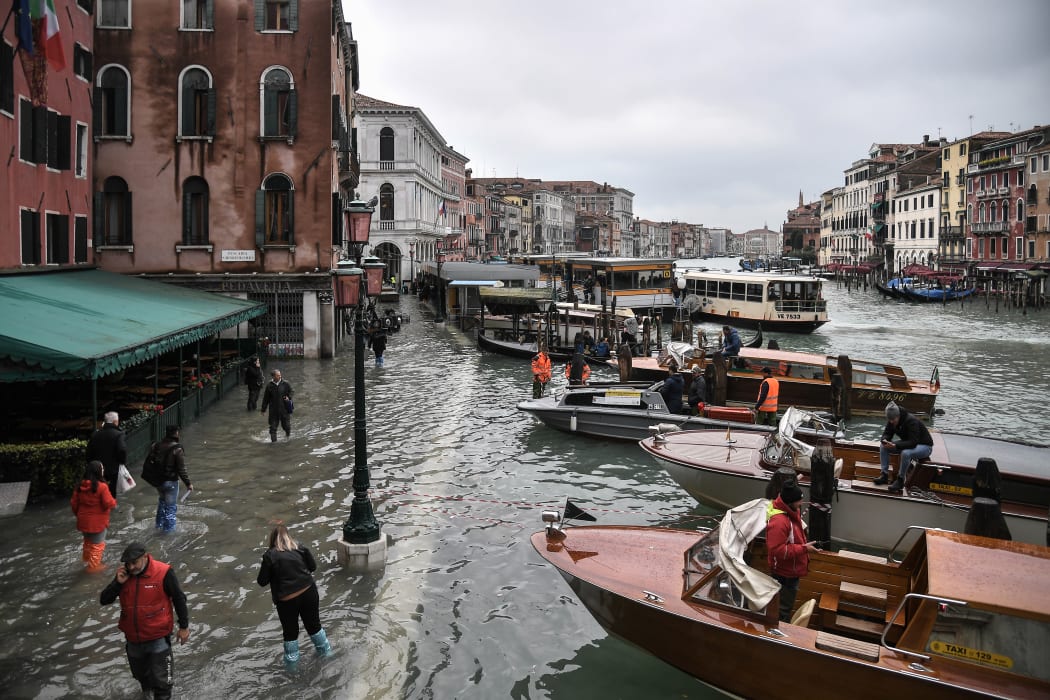 A flooded embankment by the Hotel Rialto and taxi boats on the Grand Canal channel after an exceptional overnight "Alta Acqua" high tide water level, on 13 November, 2019 in Venice.