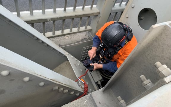 Taking photos of damage underneath the bridge.