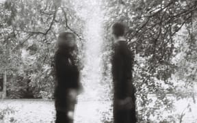 Man and woman separated by a pillar of light