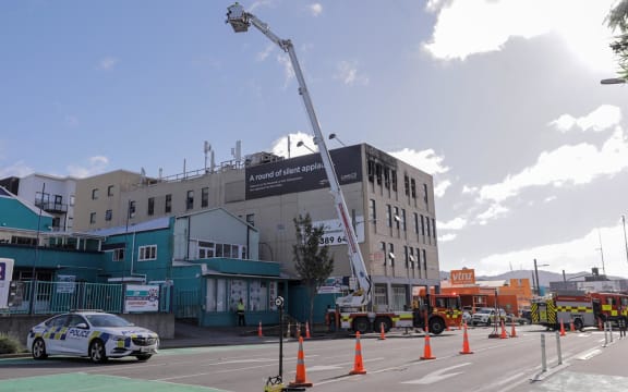 Fire investigators work at the scene following a fatal fire at Loafers Lodge in Wellington on 16 May, 2023.