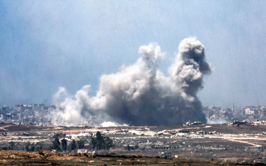 A cloud of smoke erupts following Israeli bombardment on the Gaza Strip as pictured from a position along Israel's southern border with the besieged Palestinian territory on 5 August, 2025.