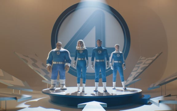 Marvel film Fantastic Four: First Steps actors Ebon Moss-Bachrach, Vanessa Kirby, Pedro Pascal, Joseph Quinn stand in the spotlight in their suits.