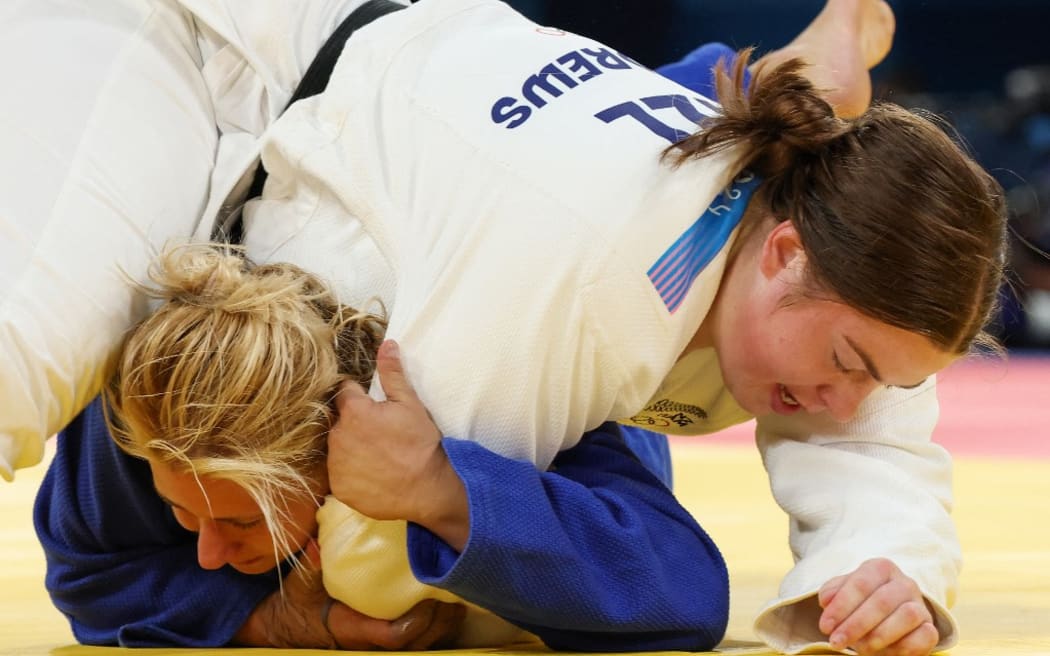 New Zealand's Sydnee Andrews and Bosnia-Herzegovina's Larisa Ceric (Blue) compete in the judo women's +78kg round of 32 bout of the Paris 2024 Olympic Games at the Champ-de-Mars Arena, in Paris on August 2, 2024. (Photo by Jack GUEZ / AFP)