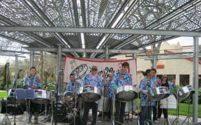 Southern Stars Steel Band. Leader Camille Nakhid is center wearing a cap.