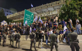 Tel Aviv, Israel: People hold Israeli flags during a sit-in demonstration as Israeli security forces work to disperse the protest against a contentious judicial overhaul by Israeli PM Benjamin Netanyahu's nationalist coalition government. 11 March, 2023