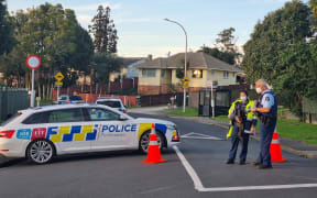 Police at the cordon around a shooting incident in the West Auckland suburb of Glendene, where two people were shot dead.