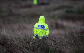 Police officer at the cordon of Alex Fisher.
