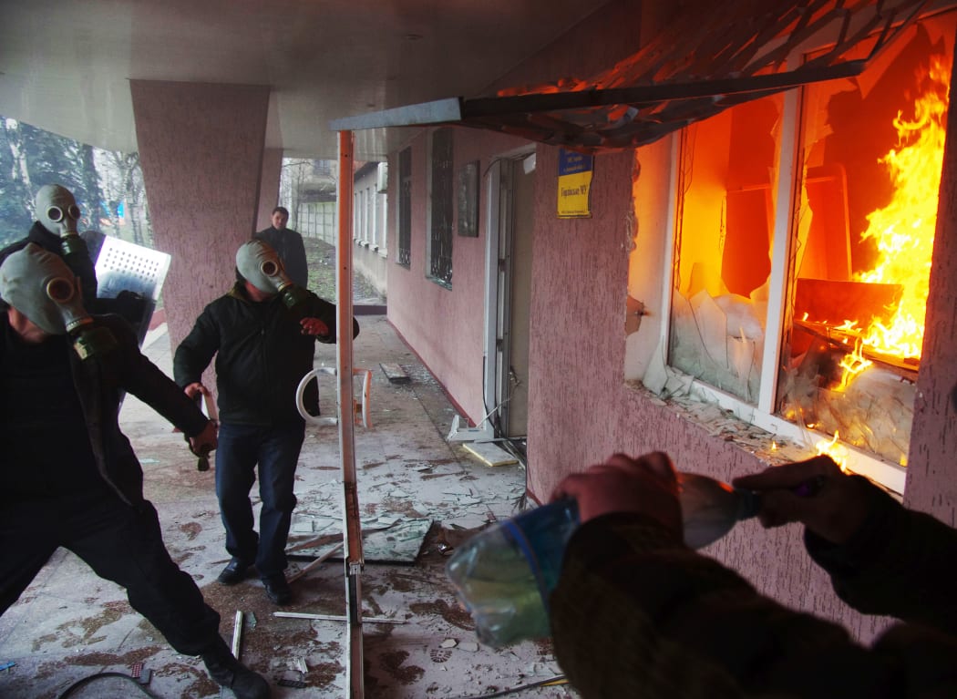 Pro-Russian protesters storm a regional police building in Horlivka.