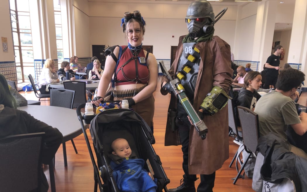 A family of three dressed up at the Wellington Games Week