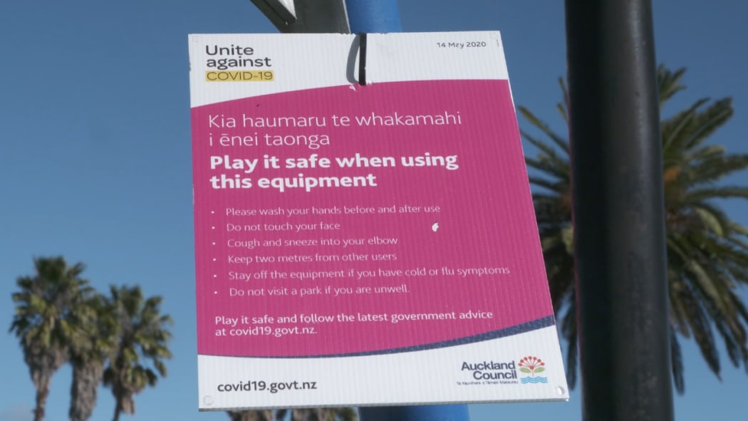 A small warning sign about Covid-19 at a public park in Auckland.