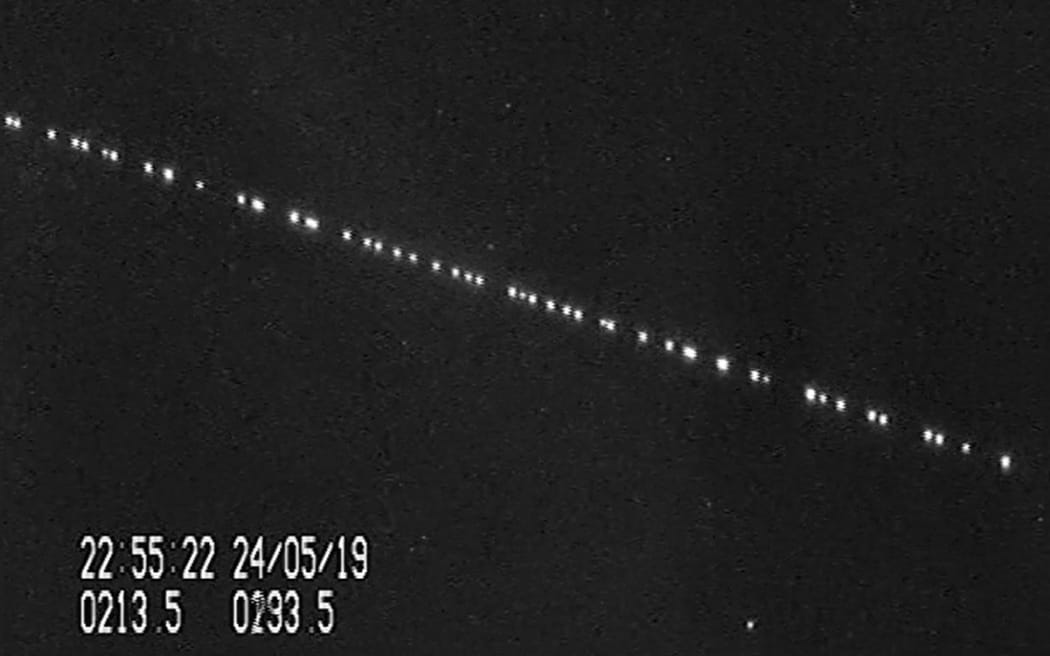 A screenshot from a video of SpaceX Starlink satellites passing over Leiden, Netherlands on 24 May, 2019.