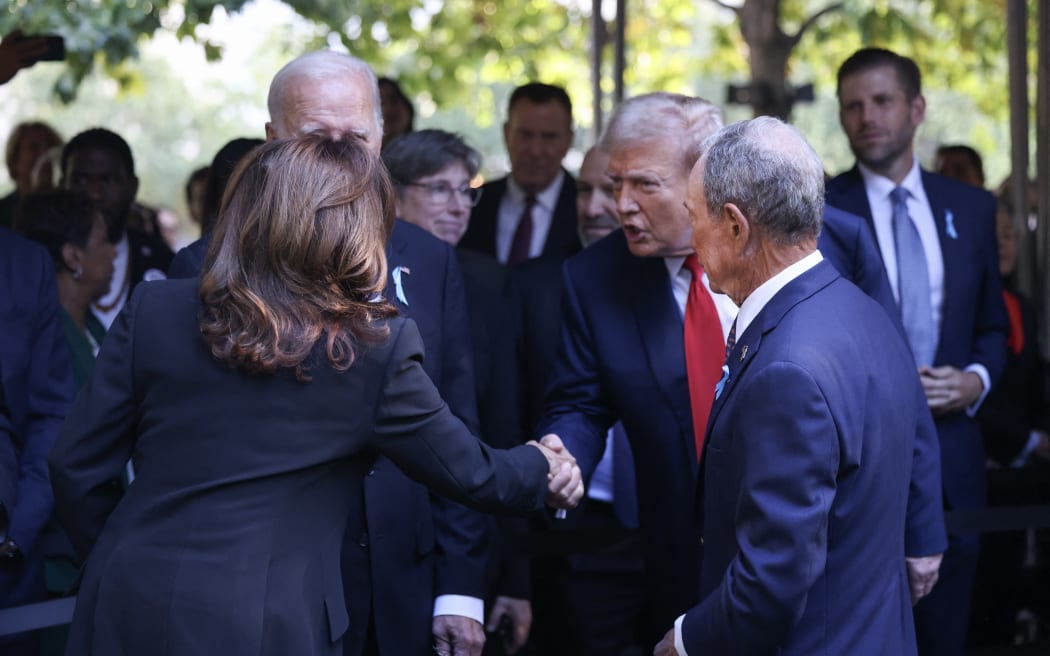 NEW YORK, NEW YORK - SEPTEMBER 11: (L-R) Democratic presidential nominee, U.S. Vice President Kamala Harris, greets Republican presidential nominee, former U.S. President Donald Trump as they joined family and friends at Ground Zero honoring the lives of those lost on the 23rd anniversary of the terror attacks of September 11, 2001, at the World Trade Center on September 11, 2024 in New York City. Harris will also attend ceremonies at the Flight 93 National Memorial in Shanksville, Pa, and the Pentagon in Arlington, Va., making visits to all three sites of the terror attacks that killed nearly 3,000 people.   Michael M. Santiago/Getty Images/AFP (Photo by Michael M. Santiago / GETTY IMAGES NORTH AMERICA / Getty Images via AFP)