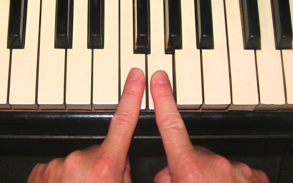Man playing chopsticks on the piano