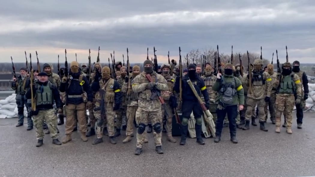 Image grab from a video released by the Ukraine defense ministry on 3March, 2022 shows Ukrainian soldiers chanting slogan as they defend the Dnieper or Dnipro river in western Ukraine.