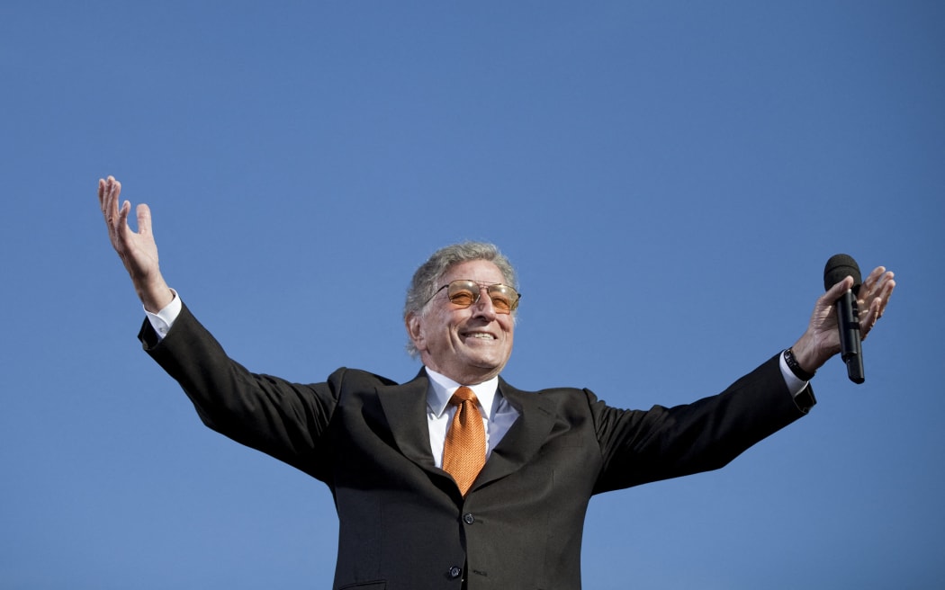 (FILES) Singer Tony Bennett performs during the "Rally To Restore Sanity and/or Fear" on the National Mall on October 30, 2010 in Washington, DC. Bennett, the last in a generation of classic American crooners whose ceaselessly cheery spirit bridged generations to make him a hitmaker across seven decades died on July 21, 2023, in New York, US media reported. He was 96. (Photo by Brendan SMIALOWSKI / AFP)