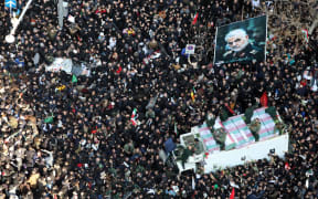 Massive crowds attend the funeral of military commander Qassem Soleimani, killed in a US drone attack.