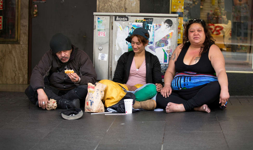 A group of people begging on Auckland's Queen Street.
