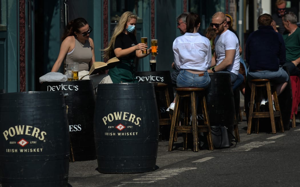 People enjoying afternoon drinks outside a pub in Dublin center.
On Monday, 21 June 2021, in Dublin, Ireland. (Photo by Artur Widak/NurPhoto) (Photo by Artur Widak / NurPhoto / NurPhoto via AFP)