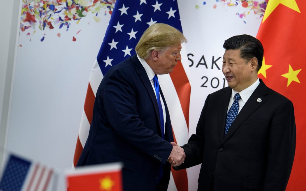 China's President Xi Jinping (R) greets US President Donald Trump before a bilateral meeting on the sidelines of the G20 Summit in Osaka on June 29, 2019.