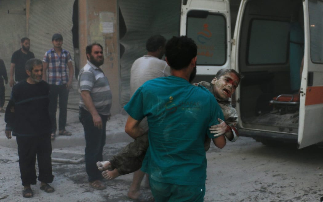 A health workers cares for the injured after airstrikes on the residential areas in the Sukkeri neighborhood of Aleppo, Syria on 28 April.