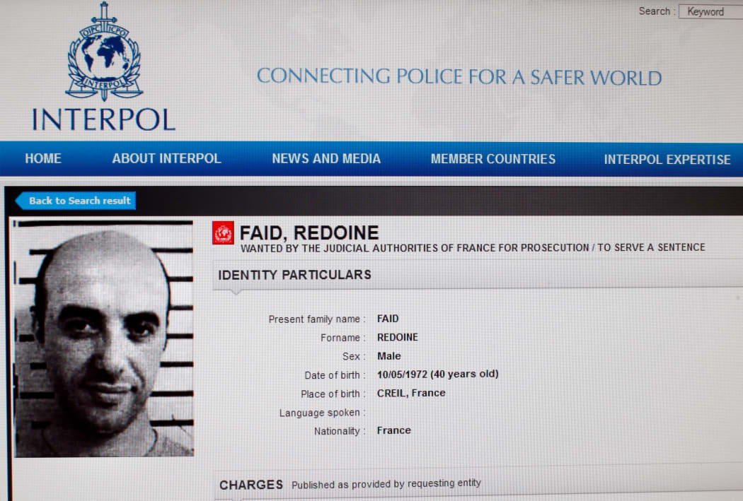 This file photo taken on April 15, 2013 in Paris shows a reproduction of the Interpol website shows the international wanted person notice for French robber Redoine Faid.