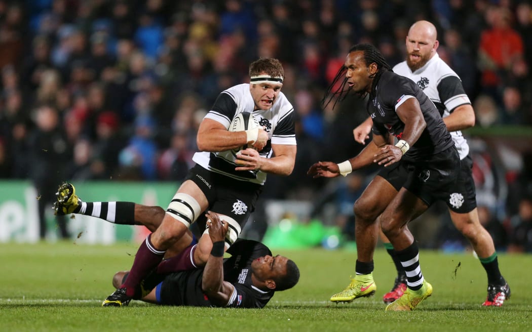 The Barbarians' Luke Whitelock is tackled by Fiji's Mosese Voka, who will captain the Fiji Giants in the Brisbane Tens.