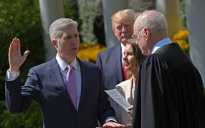 US President Donald Trump (C) watches as Justice Anthony Kennedy (R) administers the oath of office to Neil Gorsuch