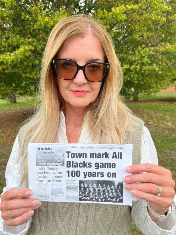 Sophie Ferguson with a copy of a Gloucestershire Echo story written by her father in 2005, 100 years after the Cheltenham v New Zealand match