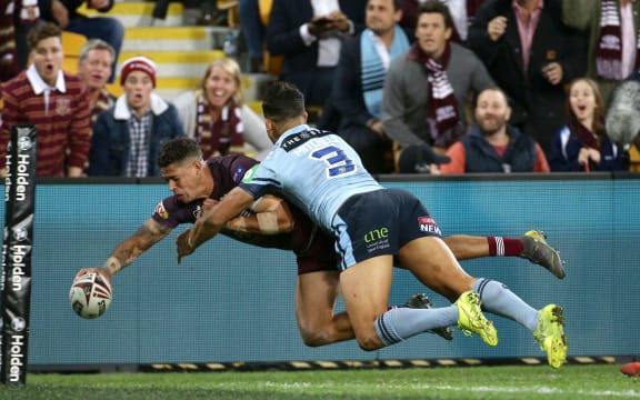 Dane Gagai of Queensland scores a try with Latrell Mitchell of New South Wales too late to stop him.