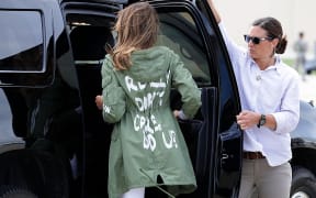 U.S. first lady Melania Trump (C) climbs back into her motorcade after traveling to Texas to visit facilities that house and care for children taken from their parents at the U.S.-Mexico border June 21, 2018 at Joint Base Andrews, Maryland.