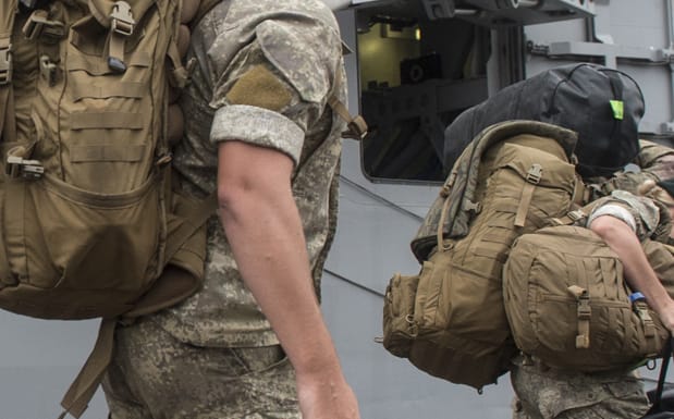 Army personnel disembark from the HMNZS Canterbury.