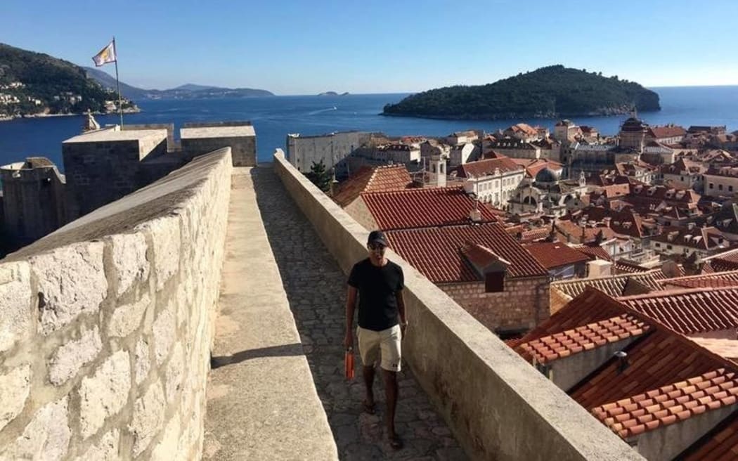 T De Silva next to the walls of Dubrovnik