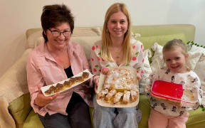Lyubov Marchenko, left, Valeriya Horyayeva and Tereza Konyk show some of the treats that will be available at the Nelson Market bake sale to support Ohmatdyt Hospital in Kyiv.