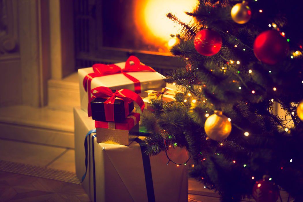 Christmas gifts wrapped under tree.