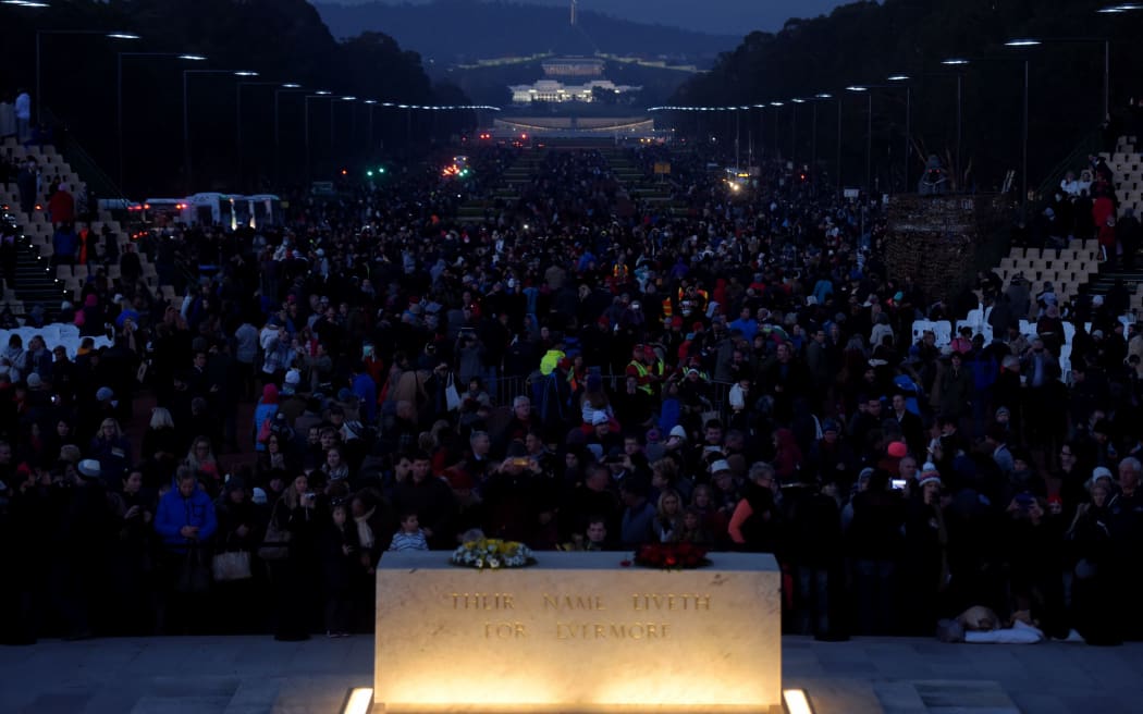 Thousands of people are seen near the stone of remembrance during the Anzac Day dawn service at the Australian War Memorial in Canberra, Saturday, April 25, 2015.